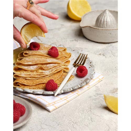 crepes with sugar, raspberries and lemon juice